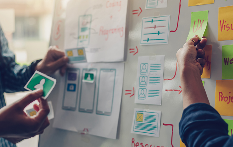 Two people collaborating on a whiteboard