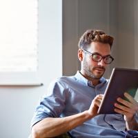 photo of a Man working on a smart tablet