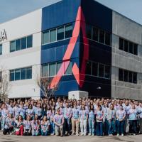 Aspida team members in front of office building