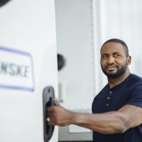Penske Logistics driver standing by truck