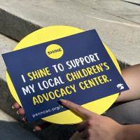SHINE walk sign that reads "I SHINE to Support My Local Children's Advocacy Center"