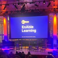 NOD Technology and the Disability Experience shot of screen on stage that reads Enable Learning