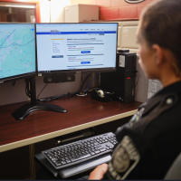 Police officer at computer taking training course