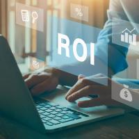 ROI text over laptop with hands on keys