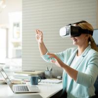 Woman at lapto with VR headset