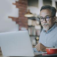 male worker using at laptop in training session 