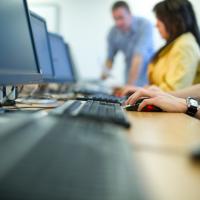 Photo of three people working on computers