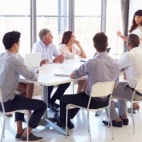 Group of people sitting at a conference table