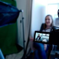 Professional Woman being filmed with camera 