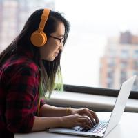 Woman at laptop with headset