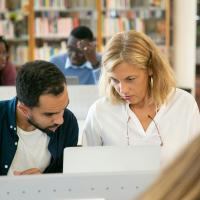 Man and woman looking at laptop