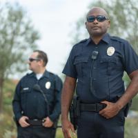Two officers in uniform standing outside