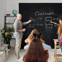 Teacher and students at chalkboard
