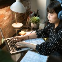 woman at computer with headset