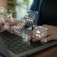 hands on keyboard with AI images floating above hands