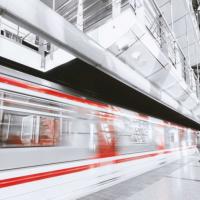 A fast moving train passing by the station