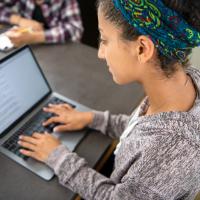 Student interacting with learning content on a laptop