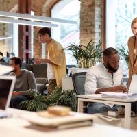 Photo Employees Working Together in an office