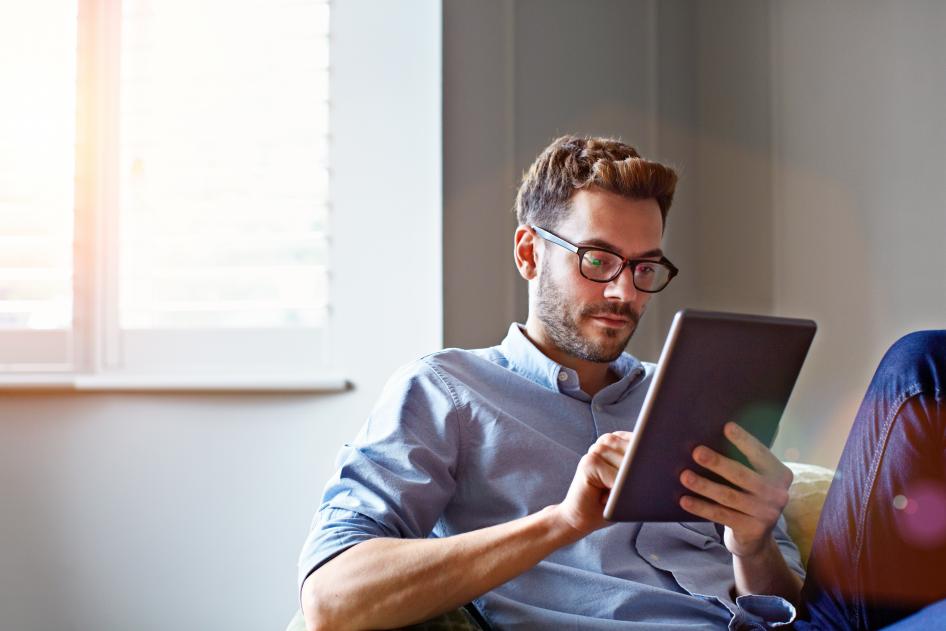 photo of a Man working on a smart tablet