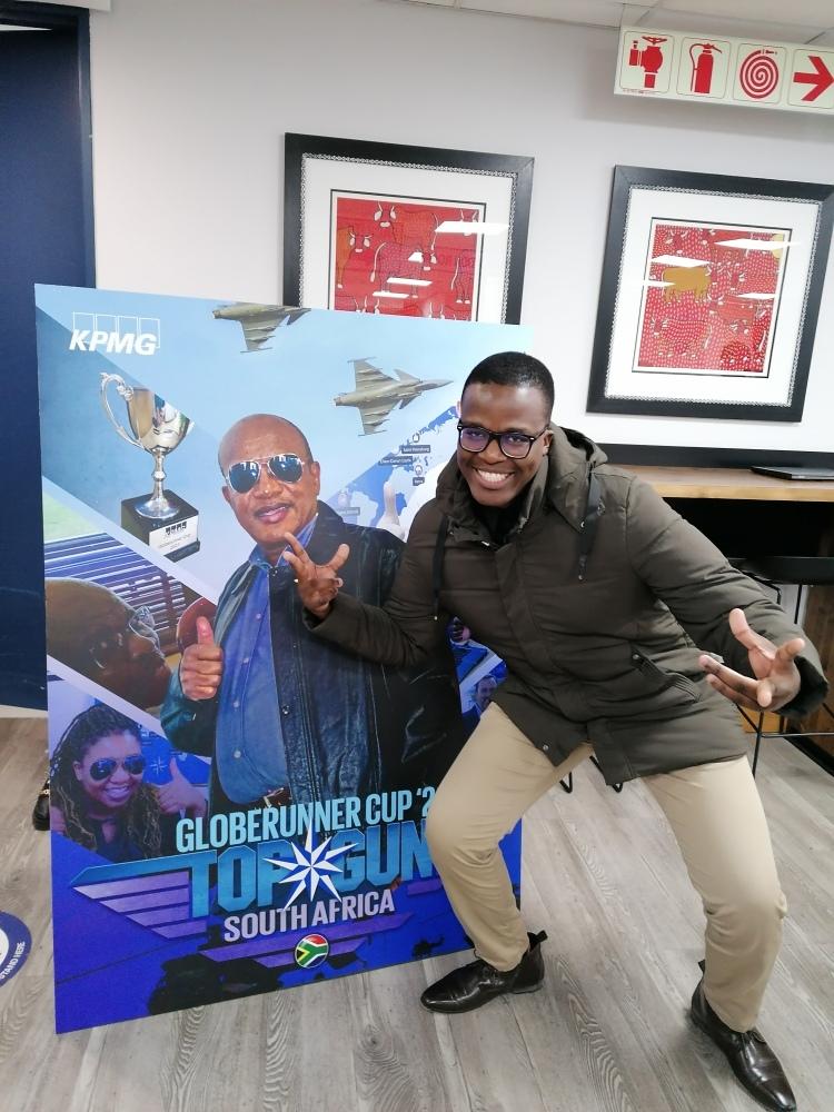 KPMG Globerunner Cup Team Member Posing by Top Gun Poster