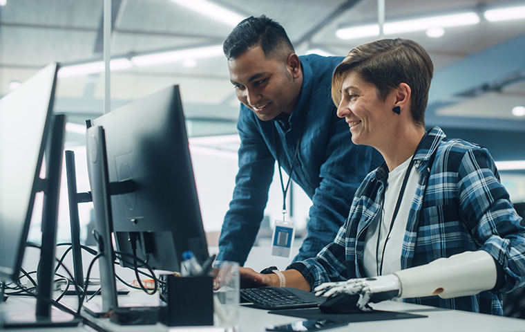 Two workers at computer