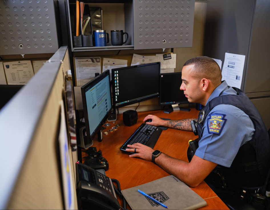 Police officer at computer taking training course