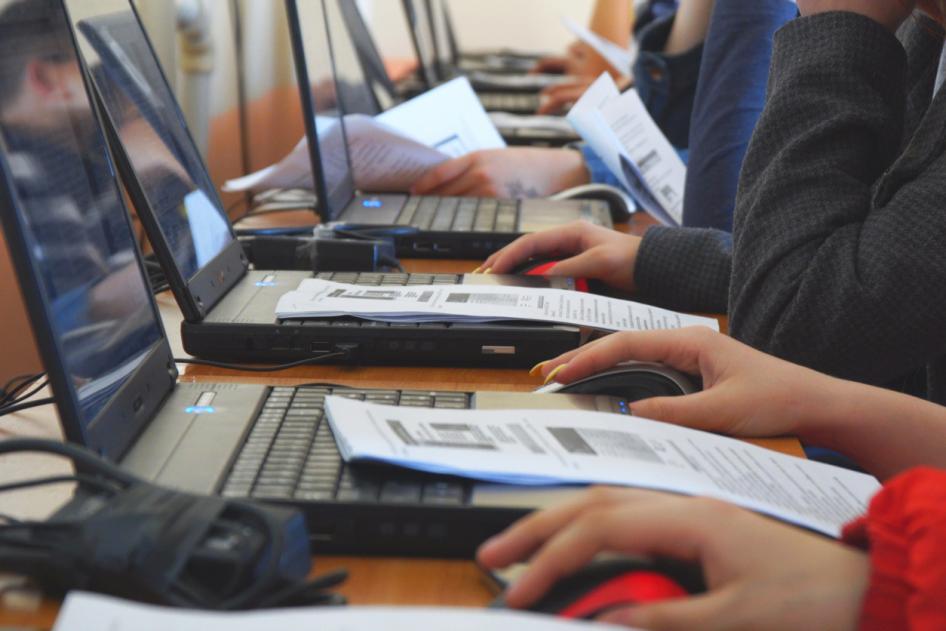 People's hands on laptops