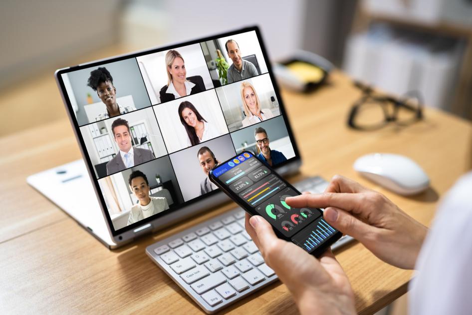 Person on phone and laptop for training meeting