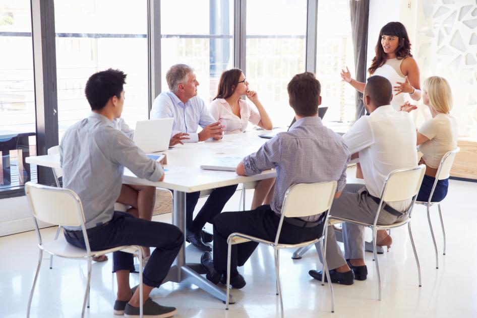 Group of people sitting at a conference table