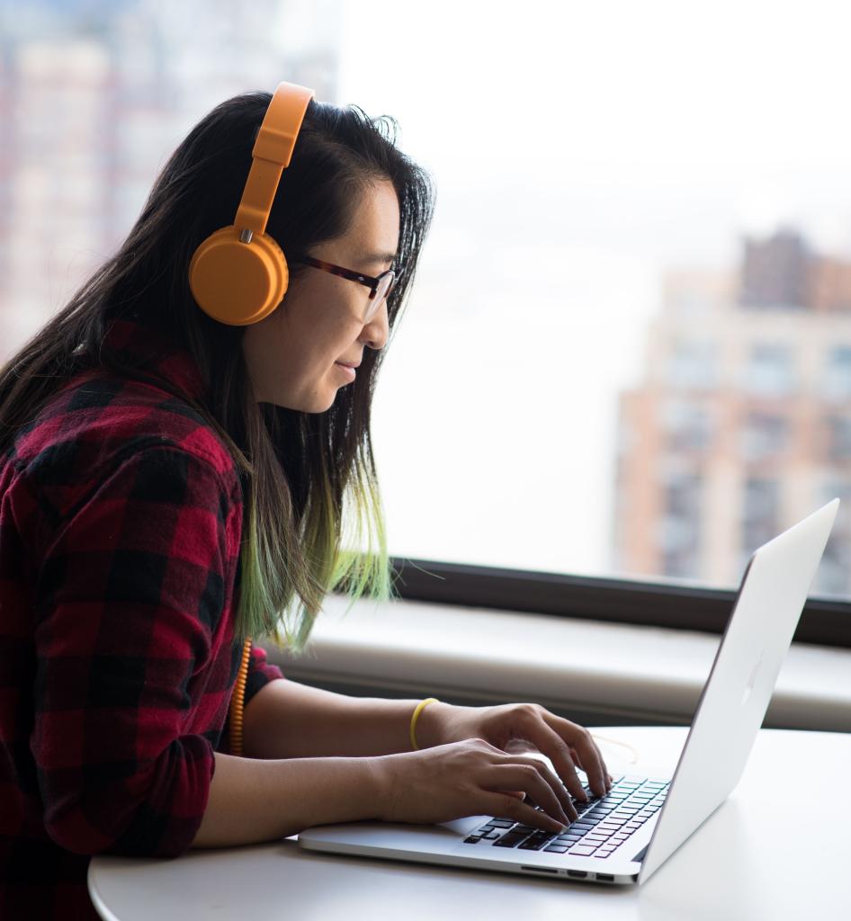 Woman at laptop with headset