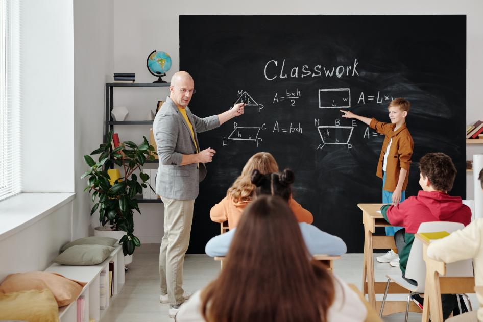 Teacher and students at chalkboard