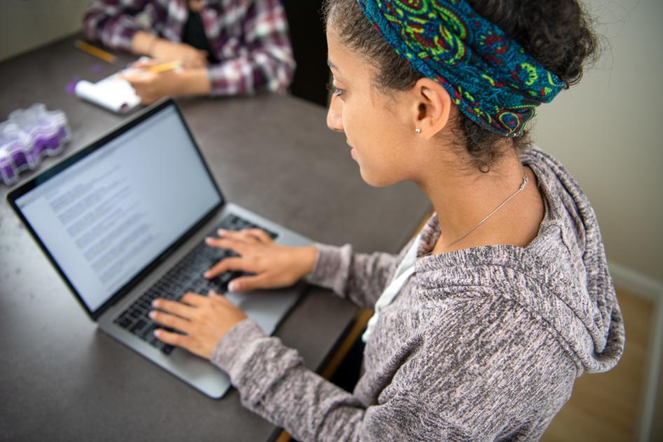 Student interacting with learning content on a laptop