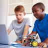 Two elementary school students working on a robotics project together