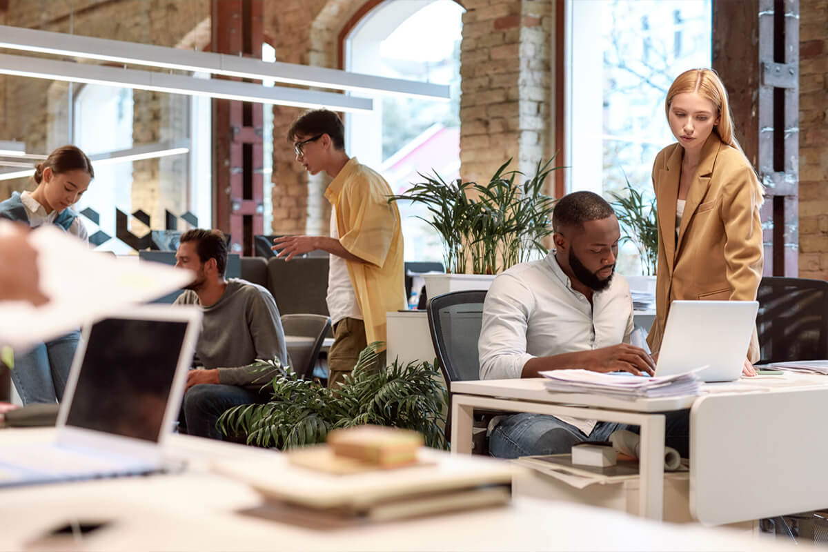 Photo of office interior with people working in the background